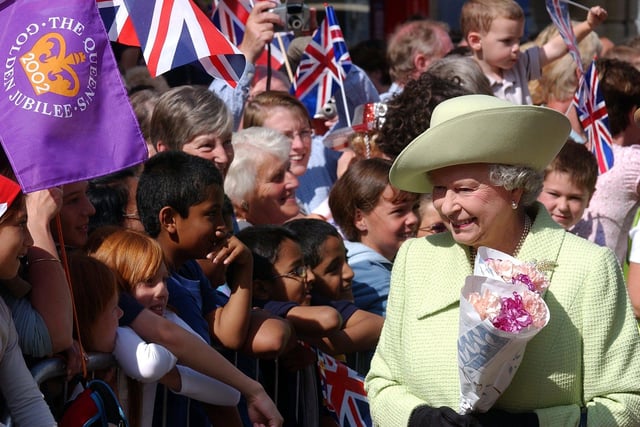A painting is presented to The Queen during her visit to Preston in 2002
