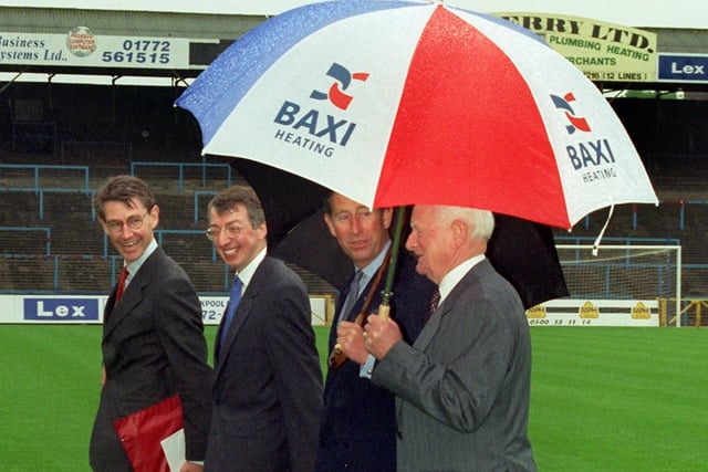 Brollies at the ready - Prince Charles with Tom Finney and officials