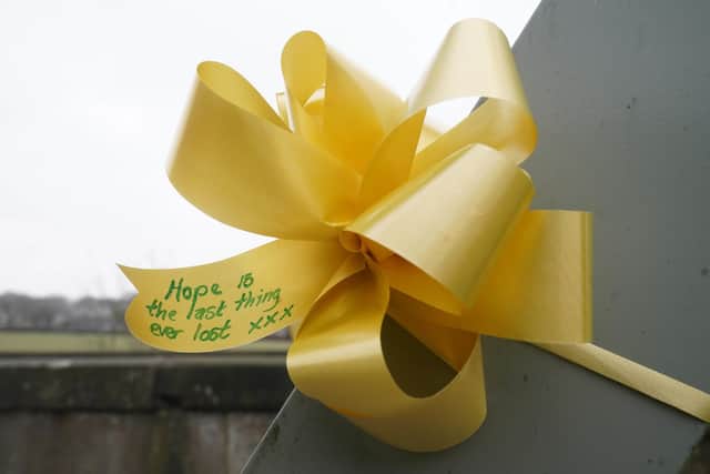 A yellow ribbon with a message of hope written on it tied to a bridge over the River Wyre (Credit: Danny Lawson/PA Wire)