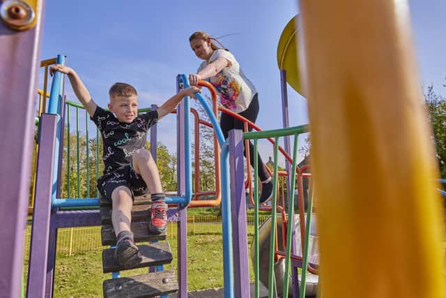 Ronnie and young brother Bradley,five,  play on a climbing frame   Photo by Dave Phillips