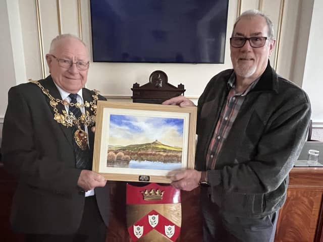 Mayor of Chorley, Tommy Gray,(left) receives the painting of Rivington Pike from Rodney Walmsley (ri