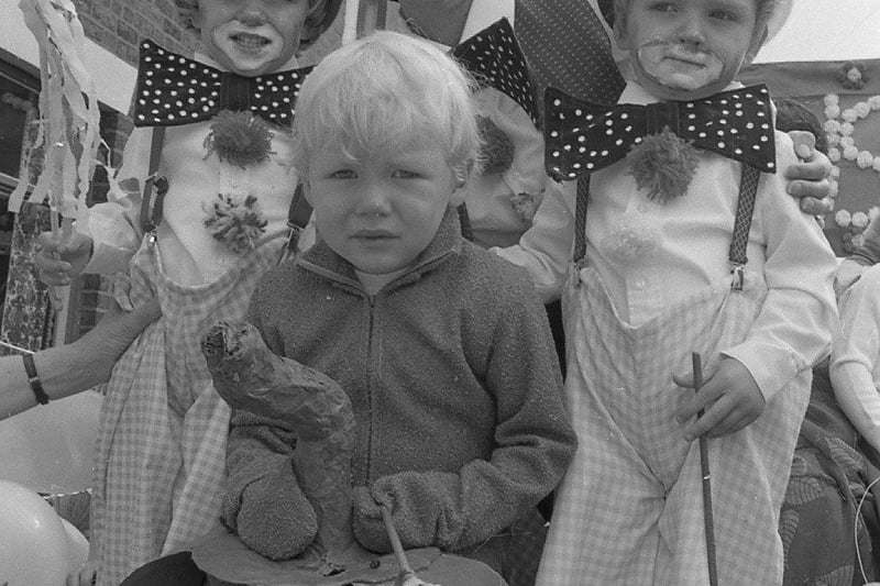 Tears among the smiles. Three-year-old Roger Breakwell keeps crying despite the smile of clowns Anne Molly and her four-year-old twins Gail (left) and Russell - who all took part in Bamber Bridge Festival