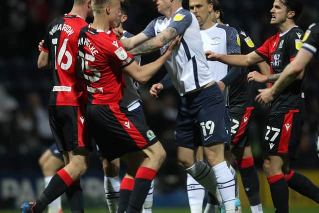 Preston North End striker Emil Riis  clashes with Blackburn Rovers' Jan Paul van Hecke