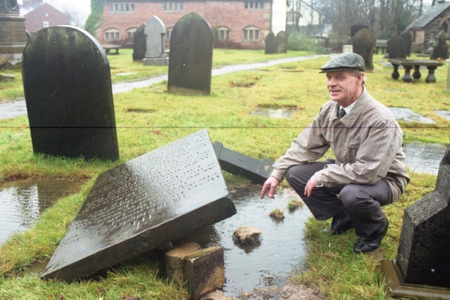 Verger Fred Ridyard inspects the damage to graves at St Andrew's CE Church in Church Road, Leyland