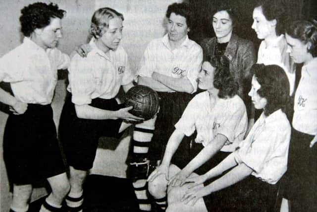 A photograph of the Dick, Kerr ladies discussing tactics. This photo was taken from the book In a League of their Own - detailing the history of the football team - courtesy of author Gail Newsham