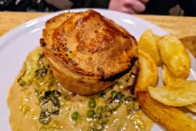 The Chef's famous chicken and ham hock pie served with creamed cabbage, peas, bacon and chips at the Four Alls Inn, Higham