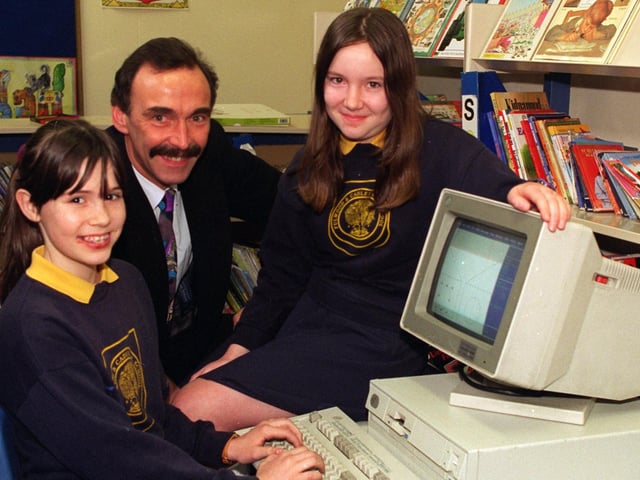 Computer whizzes Michelle Darton and Charlotte Regan, both 11, pupils at Fulwood and Cadley CP School in Fulwood, Preston, are seen with one of the seven IBM personal computers presented to the school by Bob Lonsdale, IT director with Gardner- Merchant, contract caterers of Manchester, who donated the PCs when they upgraded their computer system