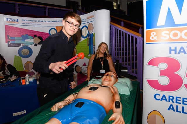 Luke Fiztgerald with Karen Gore from Lancashire Teaching Hospitals trys out a lifesize operation game at Lancashire Business Expo 2022. Photo: Kelvin Stuttard