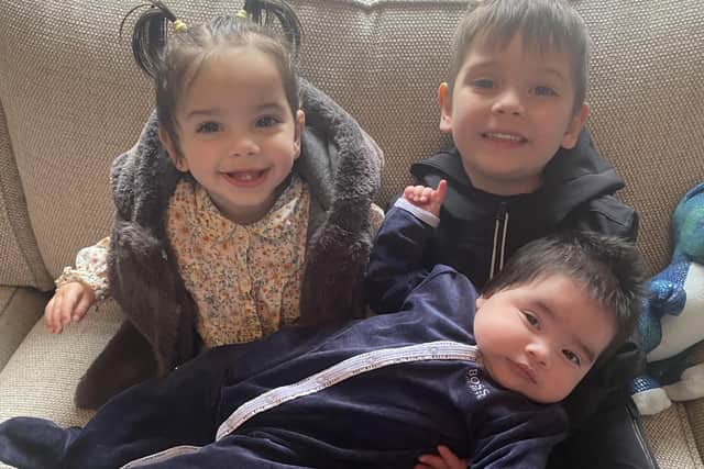 Isaac (five) and two-year-old Raiyah with their baby brother Yusuf who died of Sudden Infant Death Syndrome last year