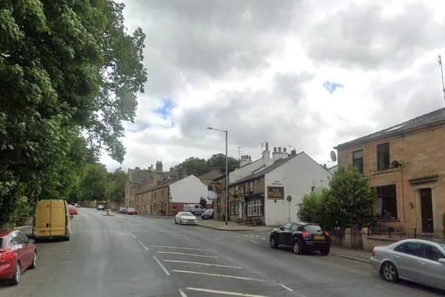 A woman died in hospital after a car collided with a building at the junction of Manchester Road and Hollins Lane in Accrington (Credit: Google)