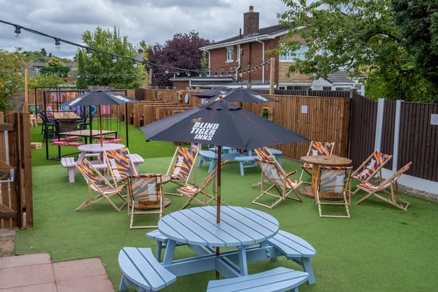 Blue tables and tiger print sun loungers adorn the beer garden
