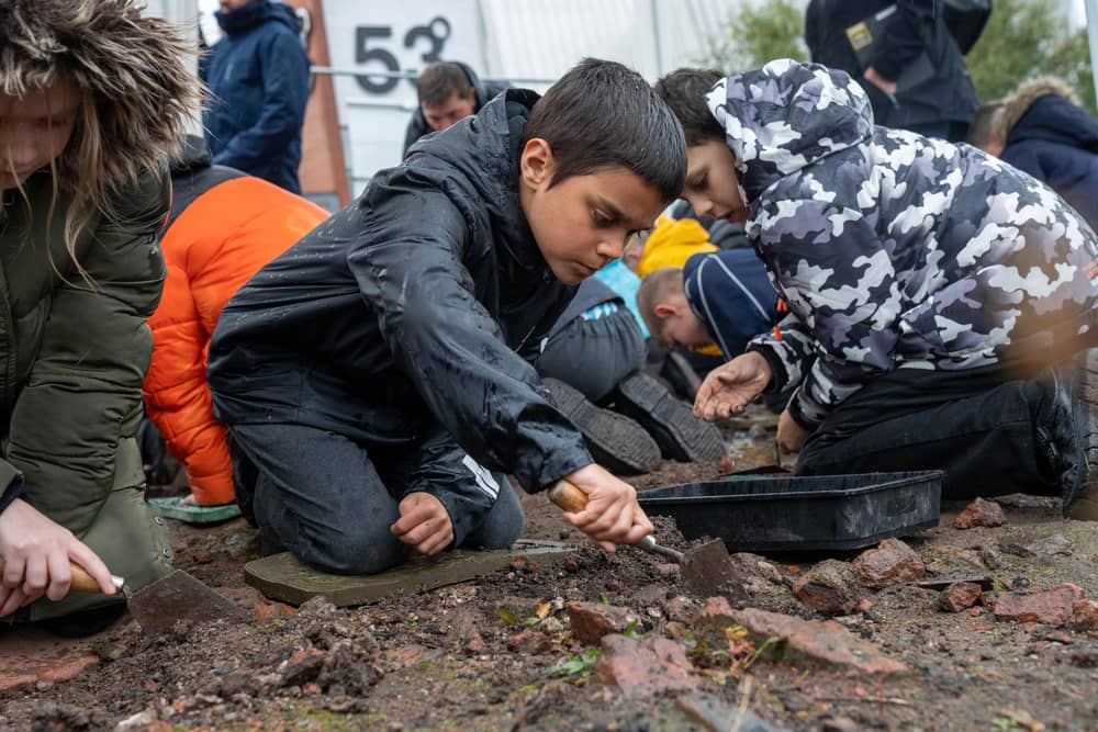 Budding archaeologists uncover ancient artefacts. Pictured: Yr 5 St Anthony's Catholic Primary School pupil Kray (centre) and Sherwood Primary School pupil Emma (right).