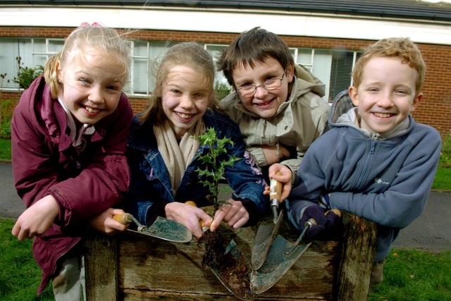 Jennifer and Stephanie Masterson, with Declan Murray and Alexander Gardner, planting a hedgerow at English Martyrs School, Preston
