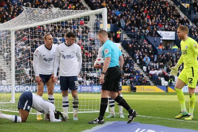 Referee Thomas Bramall checks on Daniel Johnson after awarding the spot-kick from which Preston equalised