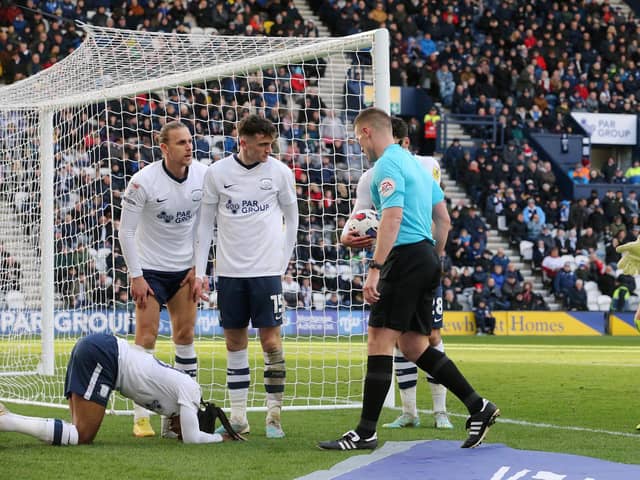 Referee Thomas Bramall checks on Daniel Johnson after awarding the spot-kick from which Preston equalised