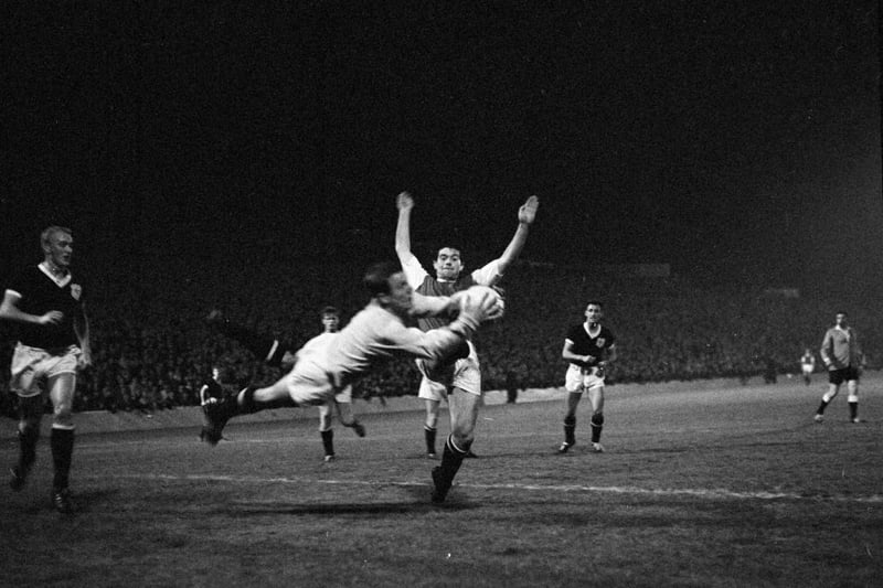 Jim Scott challenges Dundee goalkeeper Bert Slater in a League Cup quarter-final tie at Easter Road in September 1963. Hibs won 2-0.
