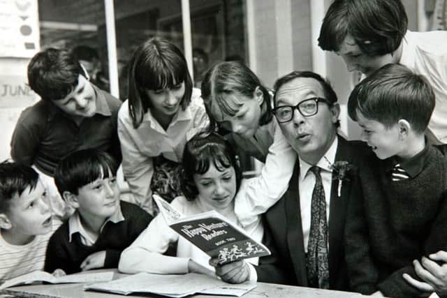 Eric Morecambe reads to youngsters in a local school in 1966