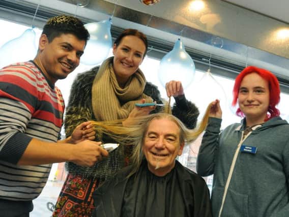 Peter Dalgleish, centre, a volunteer at Preston and District RSCPA charity shop, Market Street, Chorley, gets his long locks shaved off to raise funds for the charity, from left, barber Ali, RSCPA shops co-ordinator Claire Bradly Russell and shop volunteer