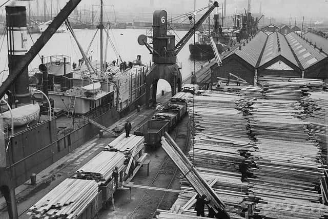 Offloading timber at Preston docks during the 1930s
