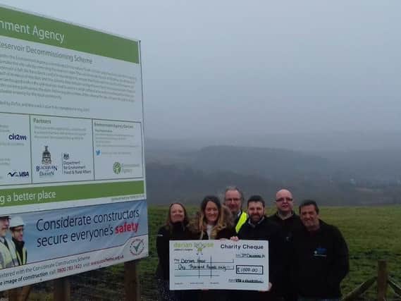 Community fund-raiser Sophie Saunders from Derian House receives a 1,000 cheque donated following a major environmental project in Darwen