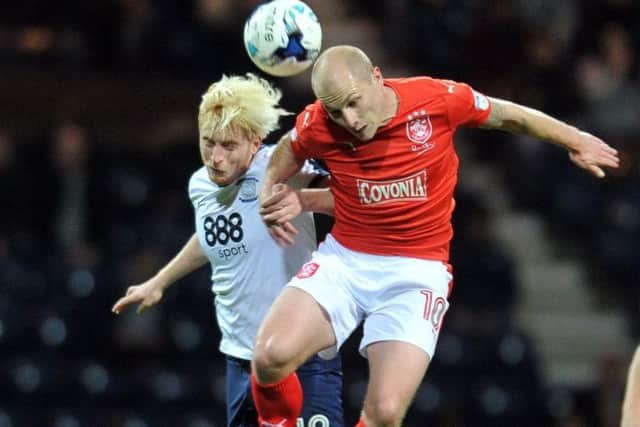 Huddersfield's Aaron Mooy is action against Ben Pringle