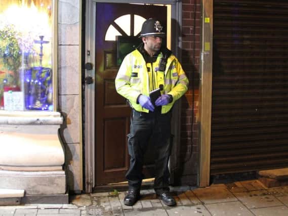 A police officer stand outside an address in Hagley Road, Birmingham, where armed police have raided a flat overnight. West Midlands Police have directed media queries to the Met Police, who have refused to discuss the incident for operational reasons
