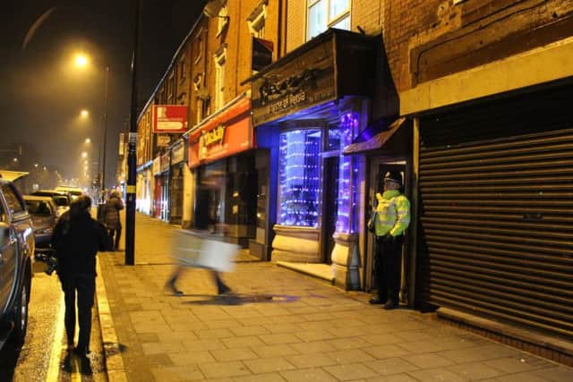 A police officer stand outside an address in Hagley Road, Birmingham, where armed police have raided a flat overnight.