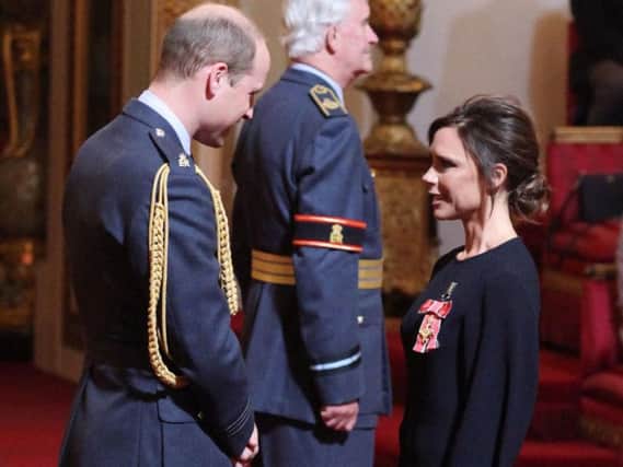 Victoria Beckham receives her OBE from the Duke of Cambridge