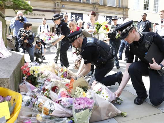 Flowers are left in St Ann's Square, Manchester, the day after a suicide bomber killed 22 people