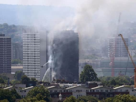 Smoke billows from a fire that has engulfed the 24-storey Grenfell Tower in west London.
