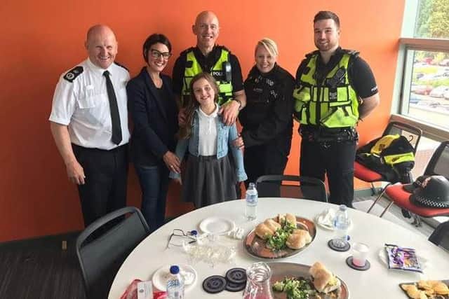 Preston police officers Sgt Luke Newman and PC Nick Cross (luminous vests) went to Durham to visit 10 year old Poppy Sutcliffe after helping her at Manchester's One Love concert.