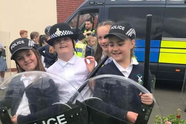 Preston police officers Sgt Luke Newman and PC Nick Cross (luminous vests) went to Durham to visit 10 year old Poppy Sutcliffe (left) after helping her at Manchester's One Love concert.