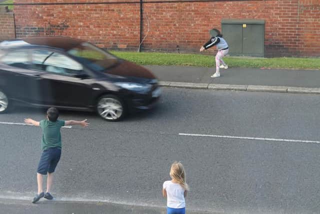 The pictures show three children who seem to be under the age of 10 doing dares on a road