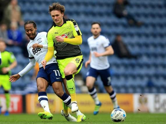 Daniel Johnson and John Swift battle during last season's meeting between the sides at Deepdale.
