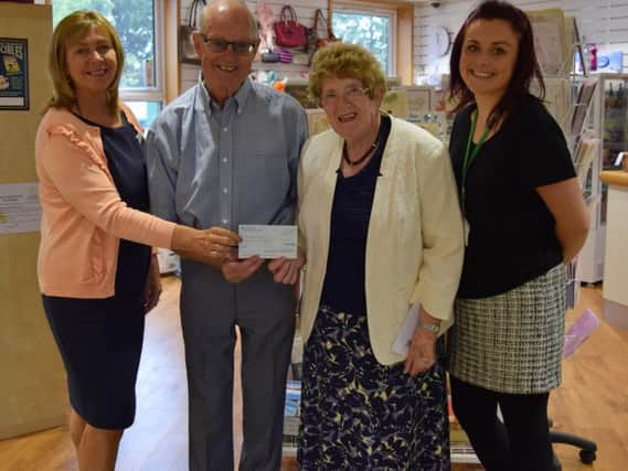 Former Mayor of South Ribble Coun Linda Woollard presents a cheque to staff and volunteers at St Catherines Hospice