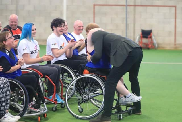 Helen Gregson, 35, gives Prince Harry a hug during his visit to the Sir Tom Finney Soccer Development Centre and the Lancashire Bombers Wheelchair Basketball Club at the University of Central Lancashire (UCLan) sports arena in Preston