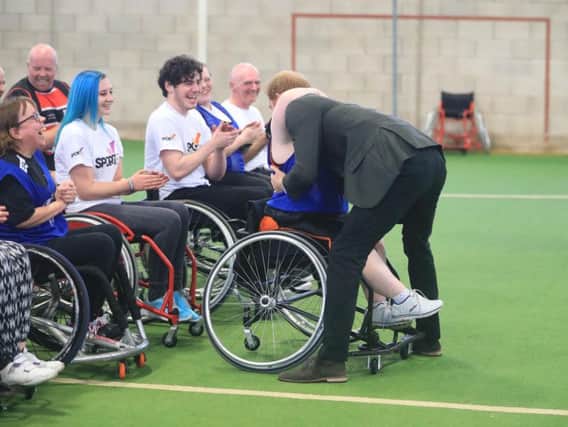 Helen Gregson, 35, gives Prince Harry a hug during his visit to the Sir Tom Finney Soccer Development Centre and the Lancashire Bombers Wheelchair Basketball Club at the University of Central Lancashire (UCLan) sports arena in Preston