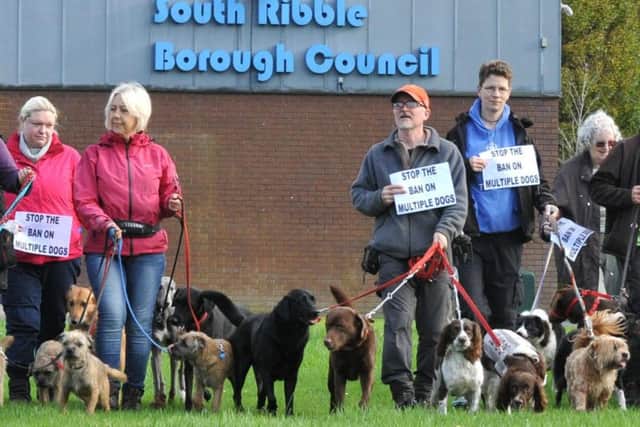 Dog walkers and dog owners protest against the council's decision to limit the number of dogs walked at any one time to four, outside South Ribble Council, Leyland.