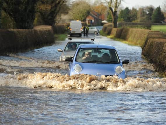 A driver braved the floods on Longmoor Lane near Garstang and subsequently got stuck. Photo: Neil Cross.