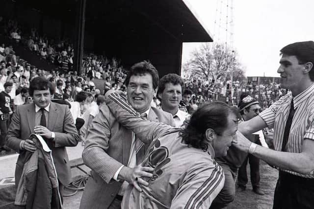 PNE boss John McGrath is congratulated by Frank Worthington at the final whistle