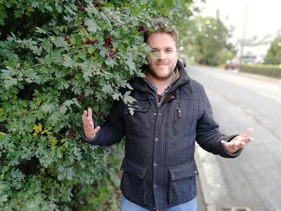 County Cllr John Potter says somebody could end up having an accident as they battle past the bushes on Lightfoot Lane's narrow pavement.