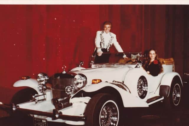 Johnny Hart on stage in Reno, Nevada with the famous Excalibur car.