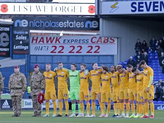 The Preston team observe a minute's silence before their game against Ipswich at Portman Road