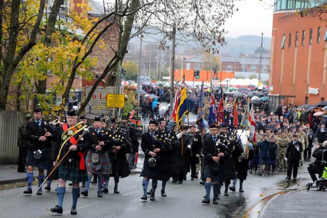 A piping band lead the way up Union Street from the Flat Iron car park