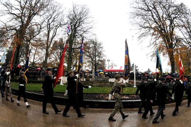 Eyes-left, as present and former service personnel arrive at the park