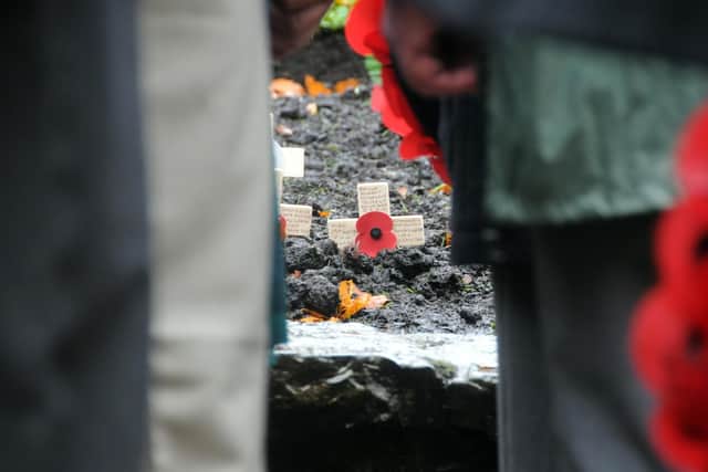 Wreaths of poppies wait to be placed in front of a remembrance garden at Astley Park