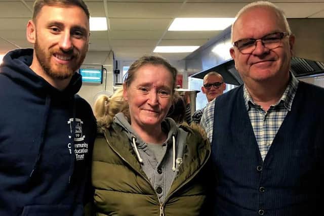 Preston North End's Louis Moult, left, with Jeff Marsh from The Foxton Centre and service user Laura