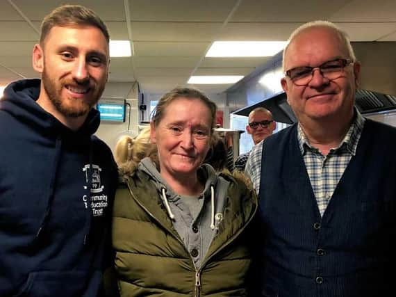 Preston North End's Louis Moult, left, with Jeff Marsh from The Foxton Centre and service user Laura
