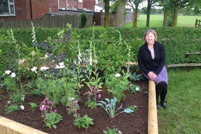 Netta Parker, chair of Catterall in Bloom, pictured by a flower bed in Catterall