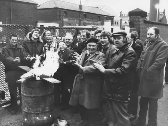 Trade unionists on strike at the Preston Council depot in Argyll Road keep warm on the picket line